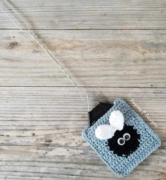 a crocheted square with a black and white sheep on it