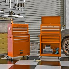 an orange tool box sitting on top of a black and white checkered floor