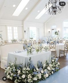 a table is set up with blue and white flowers