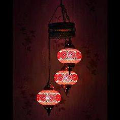 three red and white lights hanging from a ceiling