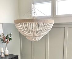 a white chandelier hanging from the ceiling in a room