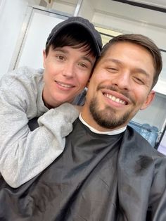 a man getting his hair cut by a woman