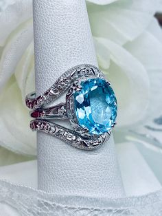 Blue Oval Stackable Rings For Anniversary, Blue Stackable Rings With Accent Stones, Silver Aquamarine Rings With Diamond Cut, Silver Aquamarine Ring With Diamond Cut, Blue Oval Stackable Promise Rings, Aquamarine Diamond Cut Ring, Blue Aquamarine Diamond Cut Rings, Blue Rings With Diamond Accents For Anniversary, Blue Oval Stackable Wedding Rings