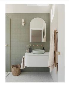 a white sink sitting under a bathroom mirror