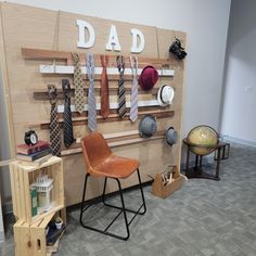 there is a display with ties and hats on the wall in this office space that says, dad