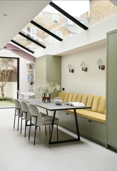 a dining room table with chairs and a bench