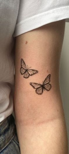 two butterflies tattoo on the arm