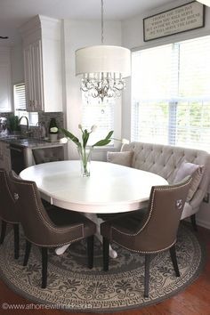 a dining room table with chairs around it and a chandelier hanging from the ceiling