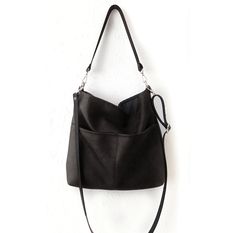 Large hobo style bag.  This is the perfect classic handbag for everyday use with plenty of room for your belongings.  Simpe and minimalistic design with clean lines.  The bag is made of premium quality artificial leather in black. It is fully lined with cotton fabric in medium grey color. Features:  -Two large front pockets - Two inner slip pockets perfect for phone, keys, cardholder etc.  -Magnetic snap closure on the top (zipper option available) -the shoulder strap and the crossbody strap (if Bag With Pockets, Hobo Crossbody Bag, Hobo Style, Hobo Bags, Classic Handbags, Leather Hobo Bag, Minimalistic Design, Hobo Handbags, Leather Hobo