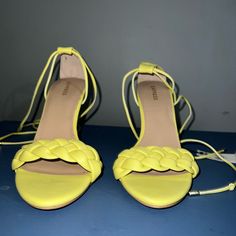 A Stylish Sandal With A Sharp Heel, Braided Strap And Lace-Up Design. Add To Any Outfit To Level Up Your Look. Yellow Sandals With 4-inch Heel For Summer, Synthetic Open Toe Lace-up Sandals With 4-inch Heel, Yellow Sandals With 4-inch Heel For Spring, Summer Lace-up Sandals With Padded Heel, Yellow Synthetic Sandals With 4-inch Heel, Summer Synthetic Heels With 4-inch Heel, Spring Lace-up Sandals With Padded Heel, Summer Yellow Heels, Medium Width, Summer Yellow Heels Medium Width