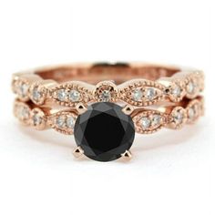 a black diamond engagement ring set in rose gold with diamonds on the band and side stones