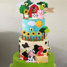 a three tiered cake with farm animals on it