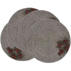 four placemats with holly decorations on them