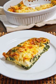 a slice of quiche on a white plate next to a casserole dish