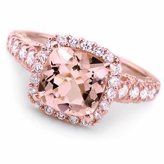 a pink diamond ring with diamonds around it