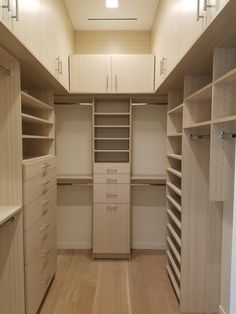 an empty walk in closet with lots of drawers