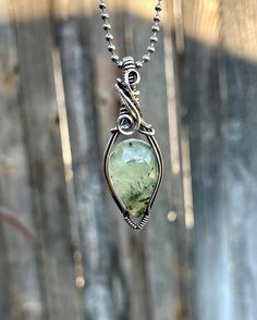 Beautiful Prehnite Pendant wrapped in solid sterling silver from Rio Grande! Full pendant measure about 0.62 inches wide and 2.11 inches tall *Prehnite is a  very versatile stone and has several benefits. It has been said to promote inner peace and spiritual growth, enhance intuition and psychic abilities, help with dream recall and/or lucid dreaming and is a powerful stone for manifestation.  *This piece has been carefully hand wrapped with sterling silver and then oxidized and polished to a hi Green Tourmaline Teardrop Jewelry, Chrysoprase Jewelry With Large Stone For Gift, Green Freeform Jewelry For Gifts, Hand Forged Green Teardrop Jewelry, Healing Hand-wrapped Moss Agate Jewelry, Green Moss Agate Jewelry With Large Stone, Handmade Fluorite Pendant Jewelry, Gift Prehnite Gemstone Jewelry, Spiritual Healing Jewelry Made Of Prehnite