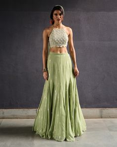 Olive green sequence work gusset skirt paired with pearl encrusted halter neck blouse and tulle dupatta.From Chamee and Palak's Anam Cara collection. DELIVERY TIMEPlease allow 8-12 weeks for your outfit to arrive. FABRIC DETAILSGeorgette, Raw Silk and Net Steam Iron & Dry Clean. Embellished Lehenga, Halter Neck Blouse, Halter Neck Blouses, Sangeet Outfit, Diwali Outfits, Green Lehenga, Muted Green, Vacuum Storage, Indian Wedding Wear