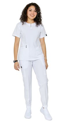 Be ready to impress the second you put on Dress A Med's Soft Stretch Silver Zipper jogger set. This 2 piece uniform scrubs set is ultra-flattering with its accent silver zipper neckline. You'll be sure to show off your figure while still maintaining your trusted and professional image. This uniform soft stretch scrubs set is made to be dazzling as you are with its accentuating double stitch lines. The scrub top is modern yet ultra-useful with a zipper compartment and 2 large pockets. The jogger White Nursing Uniform Design, Nurses Scrubs Uniform, White Scrubs Outfit, Stylish Scrubs Nurses, Scrub Uniform Ideas, Nurses Dress Uniform Style, Nurse Uniform Modern White, Scrubs Uniform Cute Medical, Stylish Scrubs For Women