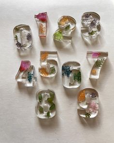 the numbers are made out of glass and have flowers on them, as well as leaves