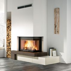 a modern fireplace with wood burning in it