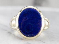 This vintage ring dates to the 1940s and has a handsome geometric, all in highly polished green gold! Particularly nice is the oval- cut lapis cabochon center, original to the piece, which makes this a truly treasured estate piece! Metal: 14K Green Gold Gem: Lapis Gem Measurements: 12.5 x 15.5 mm, Oval Ring Size: 10.50 Marks: "14" Stamped on the inside band Classic Lapis Lazuli Ring With Polished Finish, Classic Blue Oval Cabochon Signet Ring, Blue Oval Cabochon Signet Ring With Polished Finish, Formal Lapis Lazuli Oval Rings, Oval Lapis Lazuli Rings For Formal Occasions, Oval Modernist Signet Ring For Formal Occasions, Antique Oval Sapphire Ring With Polished Finish, Yellow Gold Sapphire Ring, Lapis Jewelry