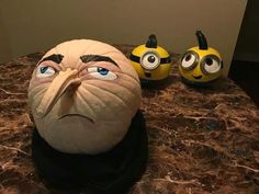 a table topped with two yellow and black minion heads sitting on top of it