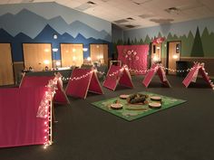 a room filled with lots of pink and green decorations on top of carpeted flooring