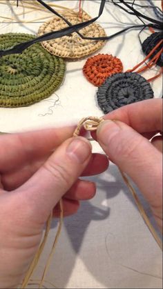 someone is working on some crocheted items with scissors and thread in their hands