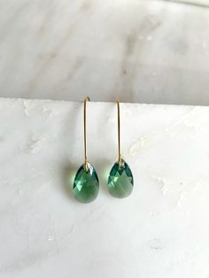 These stunning crystals hang simply alone, but with tons of sparkle. The pear-shaped drops measure 16mm and hang on plated kidney wires for a total length of about 1.75". The shade is erinite green which is bluish green. Perfect for everyday or special occasions. I have included a picture of the same design in a different shade for sizing purposes. Copyright © , all rights reserved LoveYourBling® is an authorized SWAROVSKI® Crystals Branding Partner. Long Crystal Earrings, Teardrop Earrings Gold, Bluish Green, Swarovski Crystal Earrings, Green Earrings, Swarovski Earrings, Green Crystals, Teardrop Earrings, Crystal Earrings