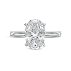 an oval cut diamond ring on a white background