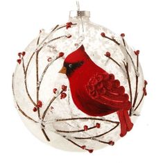 a glass ornament with a red bird on it