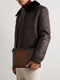 This pouch has been crafted in Italy from Berluti's 'Venezia' leather and inscribed with a signature 'Scritto' motif. Sized for documents, it's fully lined in twill and features a slip pocket inside to tuck business cards. Luxury Envelope Pouch, Luxury Brown Pouch Wallet, Modern Textured Leather Pouch For Formal Occasions, Luxury Brown Clutch, Modern Formal Textured Leather Pouch, Luxury Leather Envelope Wallet, Luxury Business Pouch, Luxury Leather Pouch, Designer Brown Leather Pouch