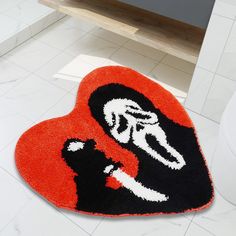 a heart shaped rug with the image of a woman holding a baby in her arms