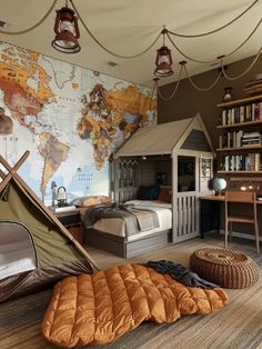 a child's bedroom with a map on the wall and a teepee tent