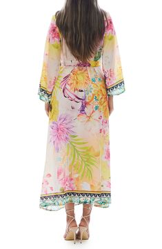 Charm your festival or beach look with this lightweight duster covered in a vibrant floral pattern. Open front Kimono-inspired sleeves 100% polyester Hand wash cold, lay flat to dry Imported Model stats: 5'10", 32" bust, 25" waist, 36" hip. Model is wearing size One Size. Floral Print Flowy Maxi Cover-up, V-neck Floral Print Festival Cover-up, Tropical Long Sleeve Cover-up For Beach Season, Flowy Long Sleeve Kimono With Floral Print, Spring Festival Flowy Cover-up, Flowy Tropical Cover-up With Floral Print, Floral Print Open Front Cover-up For Vacation, Long Cover-up For Spring Festivals, Long Festival Spring Cover-up