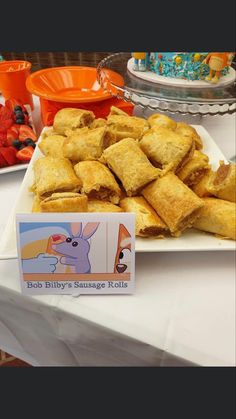 there is a plate full of pastries on the table at this children's birthday party