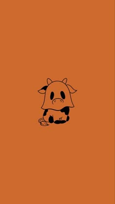 an orange background with a black and white cow sitting on it's back legs