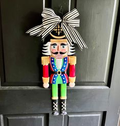 a wooden nutcracker hanging on the front door