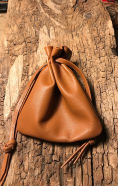 a brown leather pouch sitting on top of a wooden table