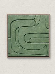 a green painting on the wall with a wooden frame