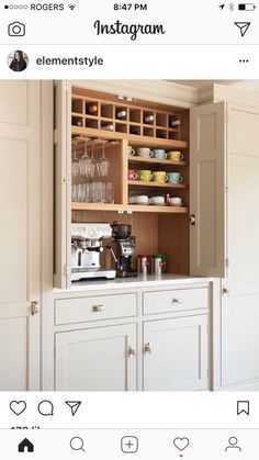 a kitchen cabinet with wine glasses and cups in it