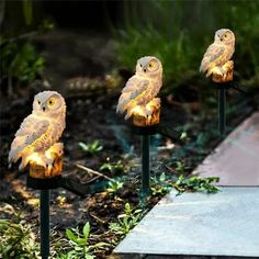 three owls sitting on top of lawn lights