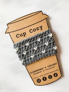 a cup cozy is sitting on top of a cardboard box and it's packaging