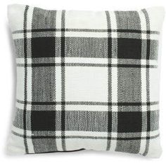 a black and white plaid pillow on a white background