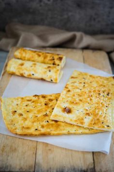 three pieces of flat bread sitting on top of a piece of paper