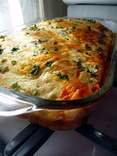 a casserole dish with cheese and vegetables in it