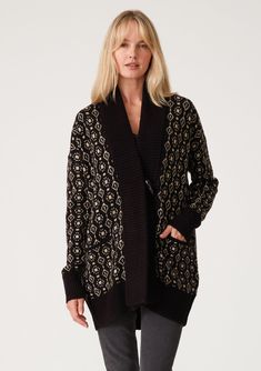 [Color: Black/Taupe] A front facing image of a blonde model wearing a cozy bohemian cardigan in a black and taupe geo jacquard design. With contrast ribbed trim Fall Jacquard Knit Cardigan For Layering, Black Jacquard Knit Long Sleeve Outerwear, Black Jacquard Knit Outerwear For Fall, Cozy Jacquard Knit Cardigan For Fall, Elegant Jacquard Knit Cardigan For Winter, Fall Workwear Jacquard Knit Cardigan, Fall Jacquard Knit Cardigan For Work, Black Jacquard Knit Cardigan For Fall, Black Fair Isle Cardigan For Fall