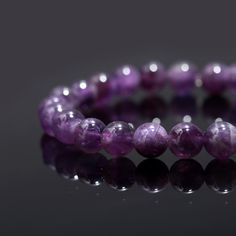 Amethyst Bead Bracelet 8 mm Round Natural Purple Amethyst Beaded Bracelet High Quality Gemstone Bead Bracelets Stone : Amethyst Shape : Round Style : Smooth Beads Size : 8 mm  Bracelet Length: 7 inch  Drill Size: 1 mm Quality : AAA+ Grade High Quality Often viewed as a stone of peace, some believe amethyst's calming presence produces soothing dreams by bringing the dreamer more in tune with the Divine. This clarity and peacefulness also extends to the waking mind. Amethysts are said to help the Purple Beaded Bracelets With 8mm Beads, Purple Bracelets With 8mm Beads As Gift, Amethyst Stretch Bracelet With 8mm Beads As Gift, Purple 8mm Beads Bracelets As Gift, Amethyst Beaded Bracelets With Faceted Beads, Round Amethyst Beaded Bracelets With Faceted Beads, Amethyst Stretch Bracelet With Round Beads For Gift, Amethyst Beaded Bracelets With 8mm Beads, Beaded Amethyst Bracelets