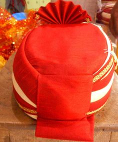 Red and cream Color pagdi. One of the long-standing customs of men, wearing Pagdi for weddings. The designer or festival pagdi are inspired by the fashion traditions of the royal families of India and hence add a regal feel to any ethnic men's outfit. The men's Pagdi hat is a classic Indian head wrap which is a necessary accessory at an Indian wedding. Latest collection make you look special on your special day wedding pagdi Package Contents: 1 Pagdi Red Sherwani With Dori Work For Diwali, Festive Red Sherwani With Dori Work, Red Dori Work Sherwani For Eid, Red Dori Work Sherwani For Festivals, Red Sherwani With Dori Work For Eid, Red Sherwani With Dori Work For Festivals, Traditional Kurta For Diwali Rituals, Red Festive Sherwani For Puja, Festive Red Sherwani For Puja